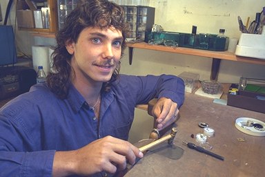 Chris at the workbench setting a gemstone